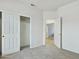 Carpeted bedroom with a closet with sliding doors and another open doorway at 6050 S Crosscreek Ct, Chandler, AZ 85249