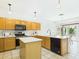 Spacious kitchen with light cabinetry, a central island, and an open layout leading to the dining area at 6050 S Crosscreek Ct, Chandler, AZ 85249