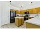 Well-lit kitchen with light wood cabinets, an island, and modern appliances at 6050 S Crosscreek Ct, Chandler, AZ 85249