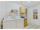 Well-lit laundry room with white washer and dryer and a window bringing in natural light at 6050 S Crosscreek Ct, Chandler, AZ 85249