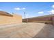 Large concrete backyard with privacy walls, partially covered with artificial turf at 61 S 111Th Pl, Mesa, AZ 85208