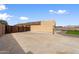 Spacious concrete backyard featuring gated access, turf accents, and complete privacy walls at 61 S 111Th Pl, Mesa, AZ 85208