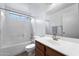 Bright bathroom with white tiled shower over tub, vanity, and window for natural light at 61 S 111Th Pl, Mesa, AZ 85208