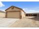 Two-car garage with gravel driveway, adjacent to the fenced backyard space at 61 S 111Th Pl, Mesa, AZ 85208