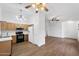 Cozy kitchen with wooden cabinets, a breakfast bar, and modern appliances at 61 S 111Th Pl, Mesa, AZ 85208