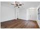 Bright living room with hardwood floors, a ceiling fan, and neutral paint at 61 S 111Th Pl, Mesa, AZ 85208