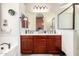 Well-lit bathroom showcasing double sinks, wooden cabinets, and a separate shower and bathtub at 8304 E Inca St, Mesa, AZ 85207