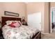 Comfortable bedroom featuring neutral walls, sliding-door closet, and a cozy bed with red throw pillows at 8304 E Inca St, Mesa, AZ 85207