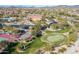 Aerial view of clubhouse, putting green, pool, tennis & basketball courts in community with lush landscaping at 8304 E Inca St, Mesa, AZ 85207