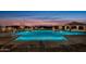 Exterior view of a well lit community pool with a desert landscape and mountain views at 8304 E Inca St, Mesa, AZ 85207