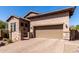 Home exterior showcasing a paver driveway, desert landscaping, and a two-car garage at 8304 E Inca St, Mesa, AZ 85207