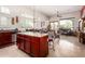 Open-concept kitchen island with stainless steel appliances, granite countertops, and tile flooring at 8304 E Inca St, Mesa, AZ 85207