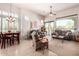 Open-concept living area with neutral tones, a large window, and a dining area for flexible living at 8304 E Inca St, Mesa, AZ 85207