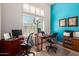 Bright office with white plantation shutters, modern desks and seating, and a vibrant blue accent wall at 8304 E Inca St, Mesa, AZ 85207