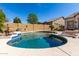 Backyard pool featuring a unique shape, a baja step, and lush landscaping at 8304 E Inca St, Mesa, AZ 85207