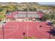 Aerial view of community basketball and tennis courts with desert landscaping and views of the mountains at 8304 E Inca St, Mesa, AZ 85207