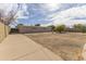 A spacious backyard that features a large concrete patio, a fence and trees at 913 N Trekell Rd, Casa Grande, AZ 85122