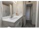 Bathroom with white vanity, cabinets, and sink, complemented by neutral walls and flooring at 913 N Trekell Rd, Casa Grande, AZ 85122