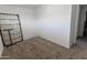 Cozy bedroom features neutral carpet, white walls, ceiling fan, and ample natural light at 913 N Trekell Rd, Casa Grande, AZ 85122