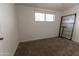 Bedroom featuring plush carpeting, white walls and natural lighting from the bright window at 913 N Trekell Rd, Casa Grande, AZ 85122