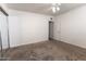 Bright bedroom showcasing neutral carpet and a ceiling fan; exit through the door at 913 N Trekell Rd, Casa Grande, AZ 85122