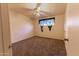 Bedroom with a window with black curtains and neutral carpeting. A ceiling fan is also visible at 913 N Trekell Rd, Casa Grande, AZ 85122