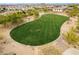 Expansive community green space featuring lush green grass and desert landscaping for outdoor enjoyment at 9305 W Calle Lejos --, Peoria, AZ 85383