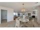 Open-concept dining area with modern light fixture, adjacent to a kitchen with a large island at 9305 W Calle Lejos --, Peoria, AZ 85383