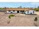 Charming home with desert landscaping, complemented by manicured green turf and gravel accents at 9305 W Calle Lejos --, Peoria, AZ 85383