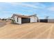 Side view of a detached two-car garage with a black door and light colored xeriscaping at 9305 W Calle Lejos --, Peoria, AZ 85383