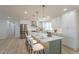 Well-lit kitchen featuring white cabinetry, stainless steel appliances, and a large island with barstool seating at 9305 W Calle Lejos --, Peoria, AZ 85383