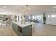 Open layout showcasing the kitchen island flowing into a stylish living area with wood floors at 9305 W Calle Lejos --, Peoria, AZ 85383