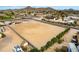 Aerial view showcases a generous vacant lot, secured by a concrete block fence, ready for construction in a peaceful neighborhood at 9305 W Calle Lejos --, Peoria, AZ 85383