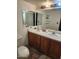 Functional bathroom featuring a double vanity, toilet, large mirror, and tile flooring at 934 S Evangeline Ave, Mesa, AZ 85208