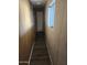 Hallway with wood-paneled walls and a door leading to other rooms at 934 S Evangeline Ave, Mesa, AZ 85208