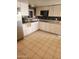 Bright kitchen with white cabinetry, stainless steel appliances, and light tile flooring at 934 S Evangeline Ave, Mesa, AZ 85208