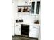 This stylish bar features a wine fridge, white cabinets, wine glass rack, and beverage storage at 9477 W Tonopah Dr, Peoria, AZ 85382
