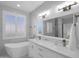 Bright bathroom featuring double sinks, modern fixtures, a soaking tub, and marble countertops at 9477 W Tonopah Dr, Peoria, AZ 85382