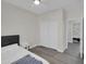 Bedroom featuring a double closet, wood laminate flooring and window with natural light at 9477 W Tonopah Dr, Peoria, AZ 85382