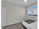 Bedroom featuring wood laminate flooring, a ceiling fan and bright window light at 9477 W Tonopah Dr, Peoria, AZ 85382