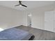 Minimalist bedroom with neutral walls, luxury vinyl floors, and an ensuite bathroom at 9477 W Tonopah Dr, Peoria, AZ 85382