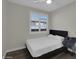 Well-lit bedroom with light gray walls, wood laminate flooring and ceiling fan at 9477 W Tonopah Dr, Peoria, AZ 85382