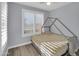 Comfortable bedroom with a ceiling fan, a shuttered window, and light colored wood floors at 9477 W Tonopah Dr, Peoria, AZ 85382