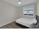 Bedroom with wood laminate flooring, ceiling fan, and bright window light at 9477 W Tonopah Dr, Peoria, AZ 85382