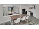 Open dining area features a wooden table and white chairs, connecting to the living room and bar area at 9477 W Tonopah Dr, Peoria, AZ 85382