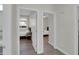 Hallway view showcasing two bedrooms with ceiling fans and wood look flooring at 9477 W Tonopah Dr, Peoria, AZ 85382