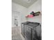 A functional laundry room featuring modern front load washer and dryer with an adjacent bathroom at 9477 W Tonopah Dr, Peoria, AZ 85382