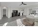 Open living area with a ceiling fan, modern entertainment center, and seamless flow to the kitchen and dining at 9477 W Tonopah Dr, Peoria, AZ 85382