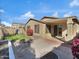 Back patio with well-manicured turf, a playset, and shaded overhang at 9477 W Tonopah Dr, Peoria, AZ 85382