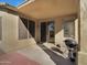 Outdoor patio area featuring a charcoal grill and sliding glass door entry to the home at 9477 W Tonopah Dr, Peoria, AZ 85382